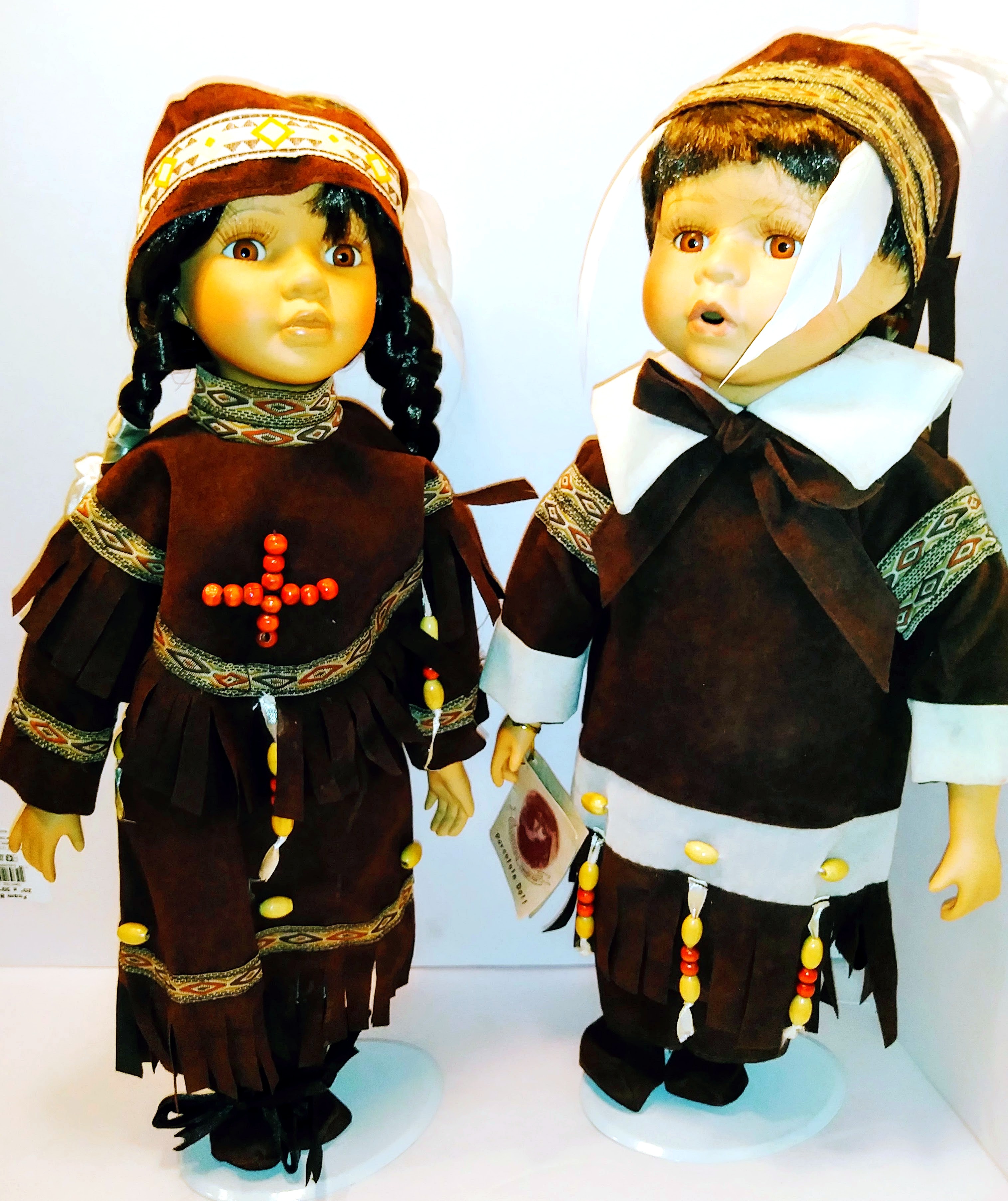 Pair of Native American Themed Porcelain Dolls